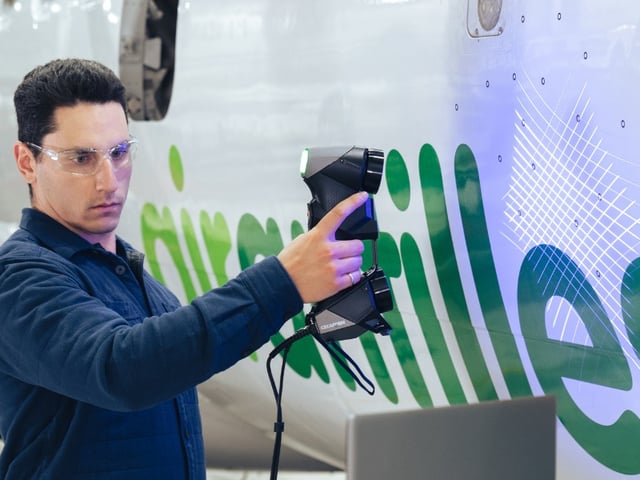 Technician scanning an aircraft fuselage for NDT surface inspection