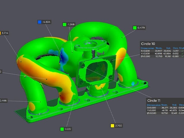 Colour deviation map and dimension callouts on an inspected cast part