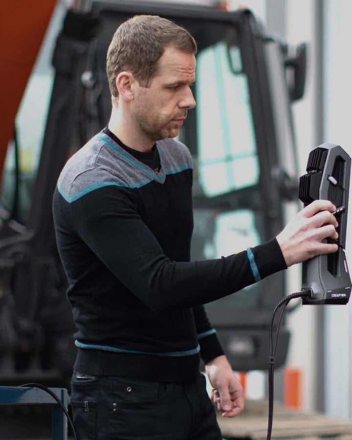 Technician using a Go!SCAN 3D scanner on industrial equipment