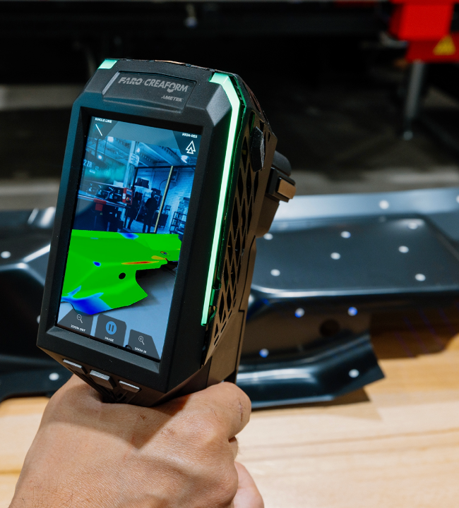 Technician inspecting a machined part with the HandySCAN 3D EVO