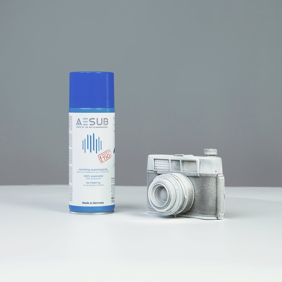 Camera body evenly coated with white AESUB 3D scanning spray
